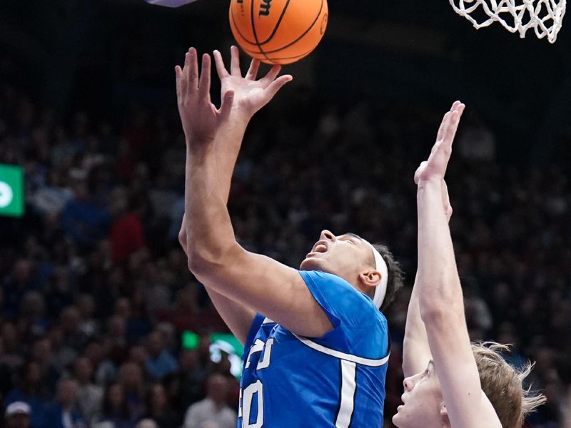 Feb 27, 2024; Lawrence, Kansas, USA; Brigham Young Cougars center Aly Khalifa (50) shoots as Kansas Jayhawks guard Johnny Furphy (10) defends during the first half at Allen Fieldhouse. Mandatory Credit: Denny Medley-USA TODAY Sports