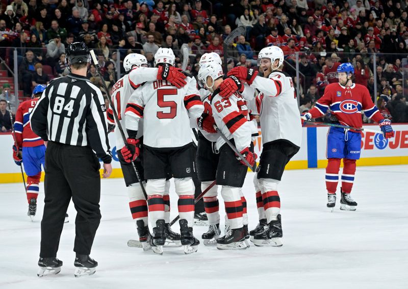 Jan 25, 2025; Montreal, Quebec, CAN;  New Jersey Devils forward Jesper Bratt (63) celebrates with teammates after scoring a goal against the Montreal Canadiens during the first period at the Bell Centre. Mandatory Credit: Eric Bolte-Imagn Images