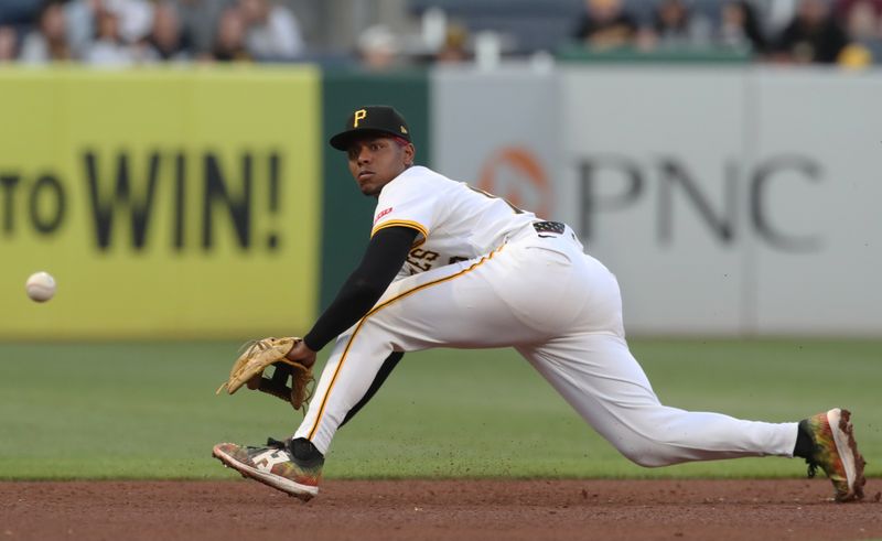 May 19, 2025; Pittsburgh, Pennsylvania, USA;  Pittsburgh Pirates third baseman Ke'Bryan Hayes (13) fields a ground ball for an out against the Cincinnati Reds during the sixth inning at PNC Park. Mandatory Credit: Charles LeClaire-Imagn Images