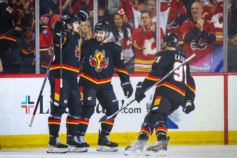 Jan 23, 2024; Calgary, Alberta, CAN; Calgary Flames defenseman MacKenzie Weegar (52) celebrates his goal with teammates against the St. Louis Blues during the first period at Scotiabank Saddledome. Mandatory Credit: Sergei Belski-USA TODAY Sports