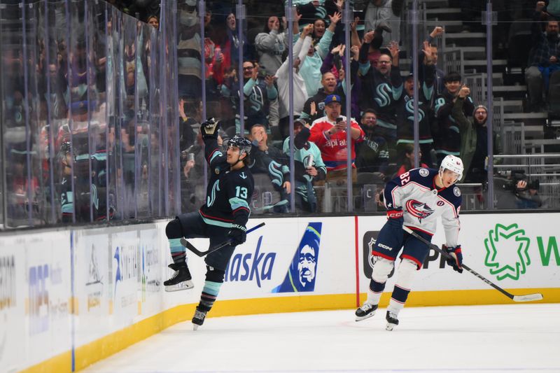 Nov 12, 2024; Seattle, Washington, USA; Seattle Kraken left wing Brandon Tanev (13) celebrates after scoring a goal against the Columbus Blue Jackets during the second period at Climate Pledge Arena. Mandatory Credit: Steven Bisig-Imagn Images