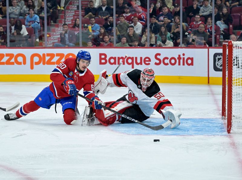 Sep 24, 2024; Montreal, Quebec, CAN; New Jersey Devils goalie Nico Daws (50) stops Montreal Canadiens forward Florian Xhekaj (60) during the third period at the Bell Centre. Mandatory Credit: Eric Bolte-Imagn Images