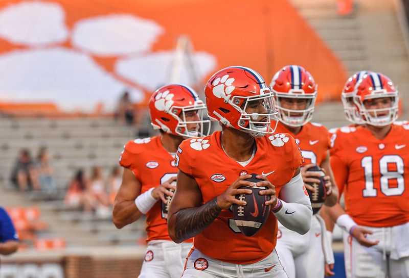 Sep 17, 2022; Clemson, South Carolina, USA; Clemson Tigers quarterback D.J. Uiagalelei (5) warms up with quarterbacks before a game against the Louisiana Tech Bulldogs at Memorial Stadium. Mandatory Credit: Ken Ruinard-USA TODAY Sports