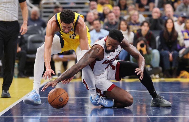 INDIANAPOLIS, INDIANA - NOVEMBER 15: Haywood Highsmith #24 of the Miami Heat and Tyrese Haliburton #0 of the Indiana Pacers battle for a loose ball during the Emirates Cup game at Gainbridge Fieldhouse on November 15, 2024 in Indianapolis, Indiana.  NOTE TO USER: User expressly acknowledges and agrees that, by downloading and or using this photograph, User is consenting to the terms and conditions of the Getty Images License Agreement. (Photo by Andy Lyons/Getty Images)