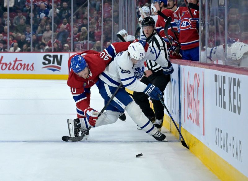 Oct 9, 2024; Montreal, Quebec, CAN; Montreal Canadiens forward Joel Armia (40) and Toronto Maple Leafs forward Pontus Holmberg (29) battle for the puck during the second period at the Bell Centre. Mandatory Credit: Eric Bolte-Imagn Images