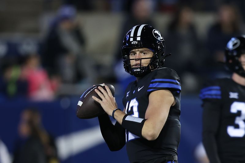 Nov 11, 2023; Provo, Utah, USA; Brigham Young Cougars quarterback Jake Retzlaff (12) warms up before the game against the Iowa State Cyclones at LaVell Edwards Stadium. Mandatory Credit: Rob Gray-USA TODAY Sports