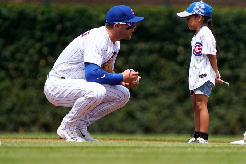 Jul 15, 2023; Chicago, Illinois, USA;  Chicago Cubs shortstop Nico Hoerner (2) signs an autograph before the game against the Boston Red Sox at Wrigley Field. Mandatory Credit: David Banks-USA TODAY Sports