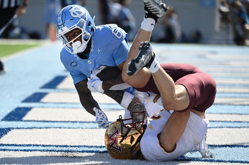 Sep 16, 2023; Chapel Hill, North Carolina, USA; North Carolina Tar Heels wide receiver Nate McCollum (6) catches a touchdown pass as Minnesota Golden Gophers defensive back Aidan Gousby (7) defends in the first quarter at Kenan Memorial Stadium. Mandatory Credit: Bob Donnan-USA TODAY Sports