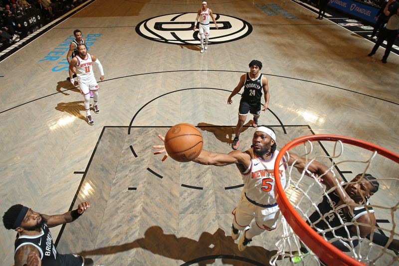 BROOKLYN, NY - JANUARY 23: Precious Achiuwa #5 of the New York Knicks rebounds during the game against the Brooklyn Nets on January 23, 2024 at Barclays Center in Brooklyn, New York. NOTE TO USER: User expressly acknowledges and agrees that, by downloading and or using this Photograph, user is consenting to the terms and conditions of the Getty Images License Agreement. Mandatory Copyright Notice: Copyright 2024 NBAE (Photo by Nathaniel S. Butler/NBAE via Getty Images)