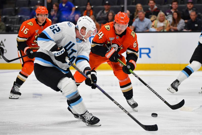 Sep 22, 2025; Anaheim, California, USA; Anaheim Ducks center Mikael Granlund (64) moves in for the puck against Utah Mammoth left wing Ben McCartney (62) during the second period at Honda Center. Mandatory Credit: Gary A. Vasquez-Imagn Images