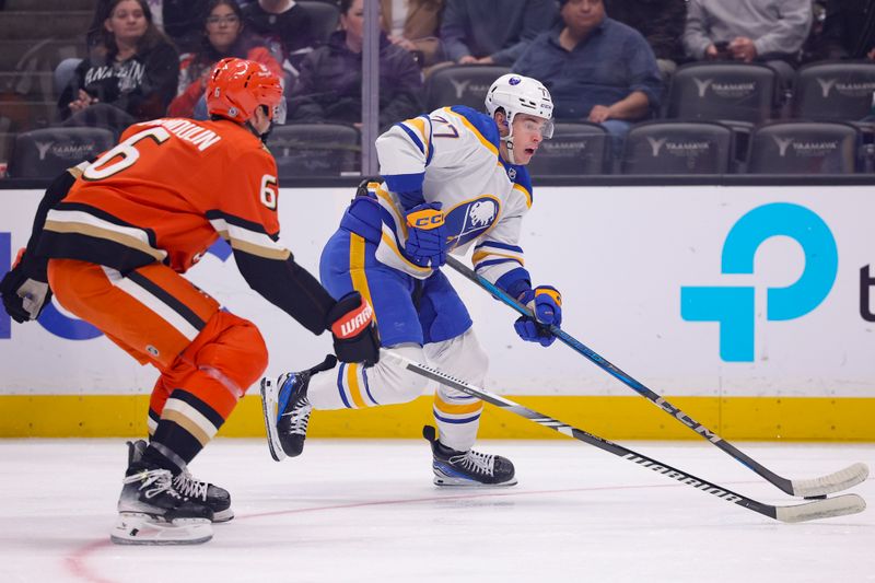 Nov 22, 2024; Anaheim, California, USA; Buffalo Sabres right wing JJ Peterka (77) moves the puck ahead of Anaheim Ducks defenseman Brian Dumoulin (6) during the first period at Honda Center. Mandatory Credit: Ryan Sun-Imagn Images