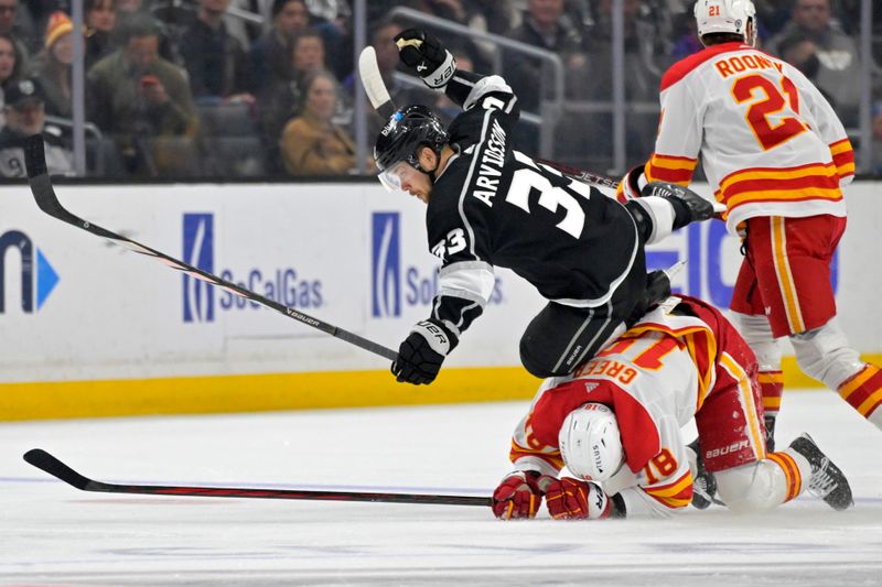 Apr 11, 2024; Los Angeles, California, USA;  Los Angeles Kings right wing Viktor Arvidsson (33) is tripped up by Calgary Flames left wing A.J. Greer (18) in the first period at Crypto.com Arena. Mandatory Credit: Jayne Kamin-Oncea-USA TODAY Sports