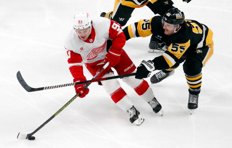 Mar 17, 2024; Pittsburgh, Pennsylvania, USA;  Detroit Red Wings right wing Alex DeBrincat (93) skates with he puck against Pittsburgh Penguins center Noel Acciari (55) during the third period at PPG Paints Arena. Pittsburgh won 6-3. Mandatory Credit: Charles LeClaire-USA TODAY Sports