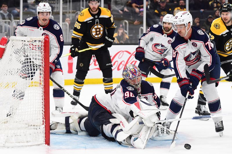 Nov 18, 2024; Boston, Massachusetts, USA;  Columbus Blue Jackets goaltender Elvis Merzlikins (90) makes a save while defenseman Damon Severson (78) looks for the rebound during the third period against the Boston Bruins at TD Garden. Mandatory Credit: Bob DeChiara-Imagn Images