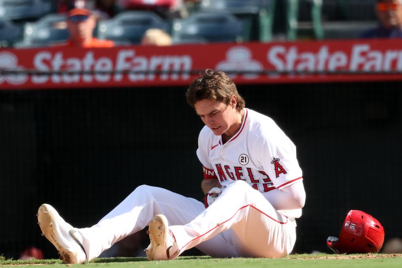 Sep 15, 2024; Anaheim, California, USA;  Los Angeles Angels center fielder Mickey Moniak (16) reacts after being hit by a pitch during the ninth inning against the Houston Astros at Angel Stadium. Mandatory Credit: Kiyoshi Mio-Imagn Images