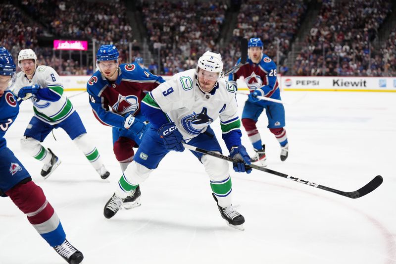 Feb 20, 2024; Denver, Colorado, USA; Vancouver Canucks center J.T. Miller (9) and Colorado Avalanche defenseman Bowen Byram (4) during the first period at Ball Arena. Mandatory Credit: Ron Chenoy-USA TODAY Sports