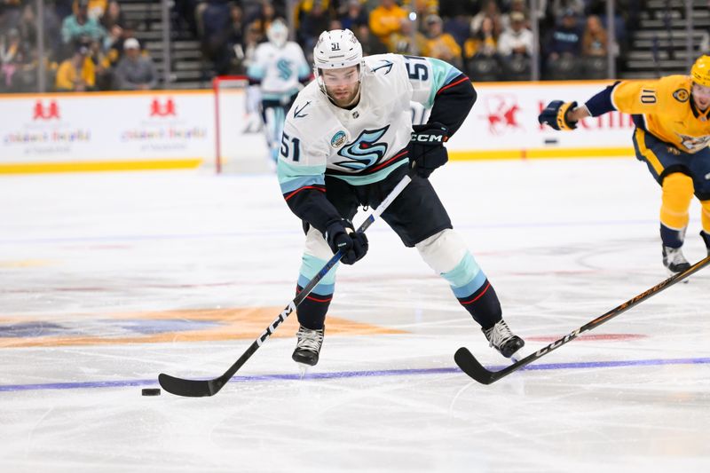 Oct 15, 2024; Nashville, Tennessee, USA;  Seattle Kraken center Shane Wright (51) skates with the puck against the Nashville Predators during the second period at Bridgestone Arena. Mandatory Credit: Steve Roberts-Imagn Images