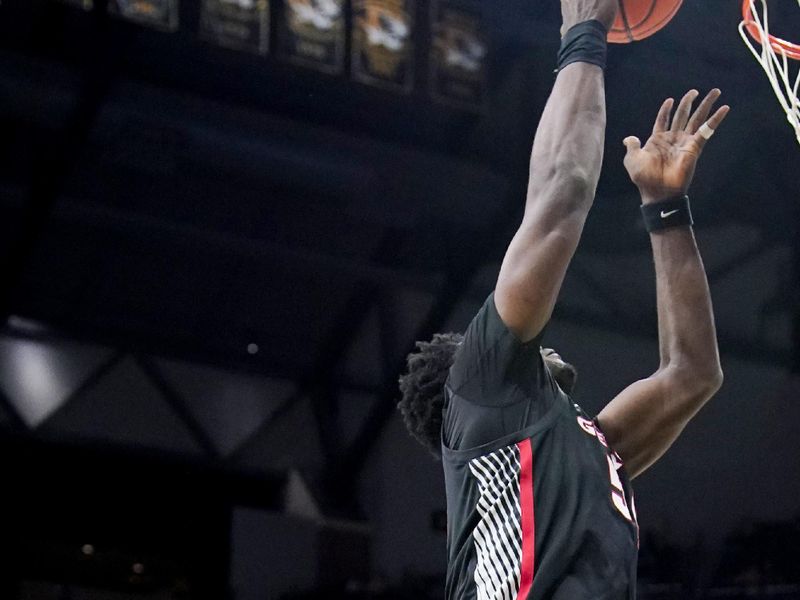 Jan 6, 2024; Columbia, Missouri, USA; Georgia Bulldogs center Russel Tchewa (54) shoots as Missouri Tigers guard Sean East II (55) looks on during the second half at Mizzou Arena. Mandatory Credit: Denny Medley-USA TODAY Sports