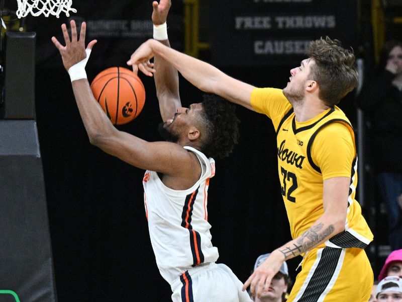 Mar 10, 2024; Iowa City, Iowa, USA; Iowa Hawkeyes forward Owen Freeman (32) blocks the shot of Illinois Fighting Illini forward Quincy Guerrier (13) during the second half at Carver-Hawkeye Arena. Mandatory Credit: Jeffrey Becker-USA TODAY Sports