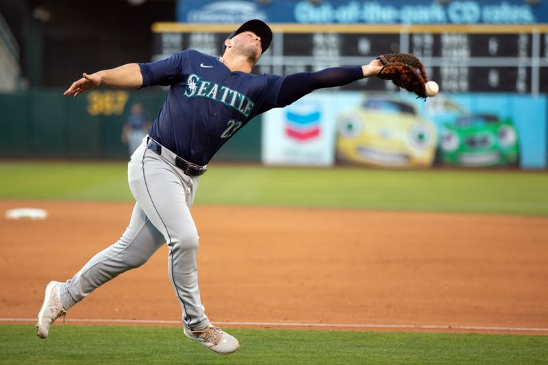 Jun 5, 2024; Oakland, California, USA; Seattle Mariners first baseman Ty France (23) drops a foul popup by Oakland Athletics designated hitter Brent Rooker during the fourth inning at Oakland-Alameda County Coliseum. Mandatory Credit: D. Ross Cameron-USA TODAY Sports