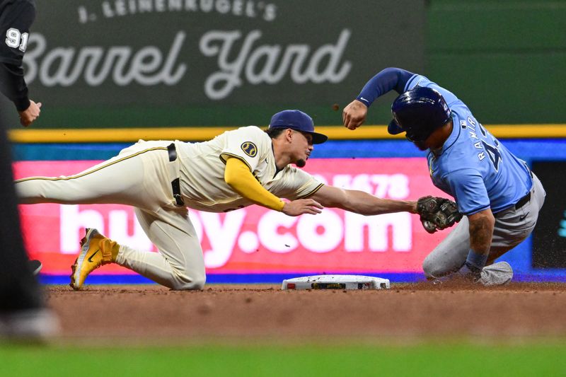 Apr 30, 2024; Milwaukee, Wisconsin, USA; Milwaukee Brewers shortstop Willy Adames (27) tags out Tampa Bay Rays designated hitter Harold Ramirez (43) trying to steal second base in the fifth inning at American Family Field. Mandatory Credit: Benny Sieu-USA TODAY Sports