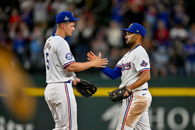 Apr 10, 2024; Arlington, Texas, USA; Texas Rangers shortstop Corey Seager (5) and second baseman Marcus Semien (2) celebrate after the Rangers defeat the Oakland Athletics at Globe Life Field. Mandatory Credit: Jerome Miron-USA TODAY Sports