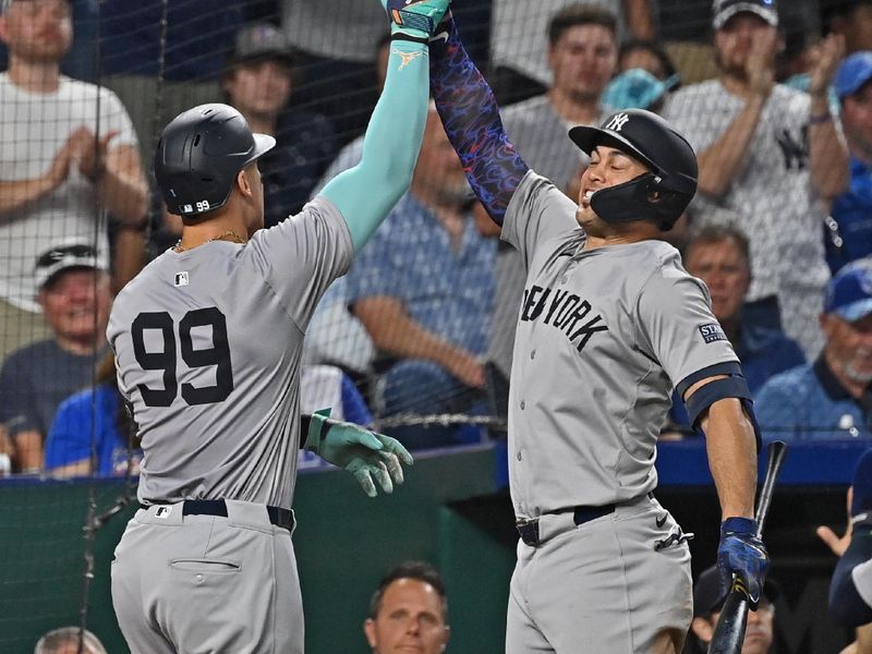 Jun 11, 2024; Kansas City, Missouri, USA; New York Yankees center fielder Aaron Judge (99) celebrates with Giancarlo Stanton (27) after hitting a two-run home run in the seventh inning against the Kansas City Royals at Kauffman Stadium. Mandatory Credit: Peter Aiken-USA TODAY Sports