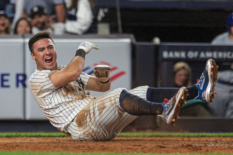 Sep 11, 2024; Bronx, New York, USA; New York Yankees shortstop Anthony Volpe (11) reacts after scoring a run on a sacrifice fly by catcher Austin Wells (not pictured) during the tenth inning against the Kansas City Royals at Yankee Stadium. Mandatory Credit: Vincent Carchietta-Imagn Images