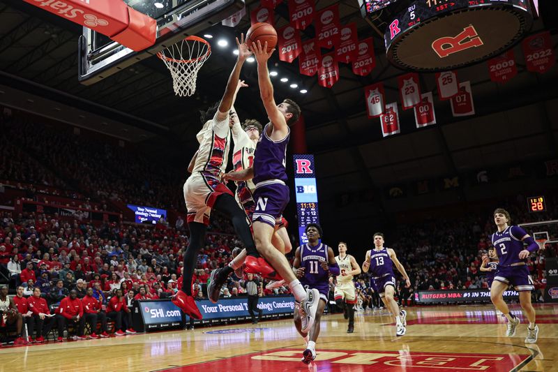 Feb 15, 2024; Piscataway, New Jersey, USA; Northwestern Wildcats guard Ryan Langborg (5) drives to the basket against Rutgers Scarlet Knights center Emmanuel Ogbole (22) and guard Gavin Griffiths (10) during the first half at Jersey Mike's Arena. Mandatory Credit: Vincent Carchietta-USA TODAY Sports