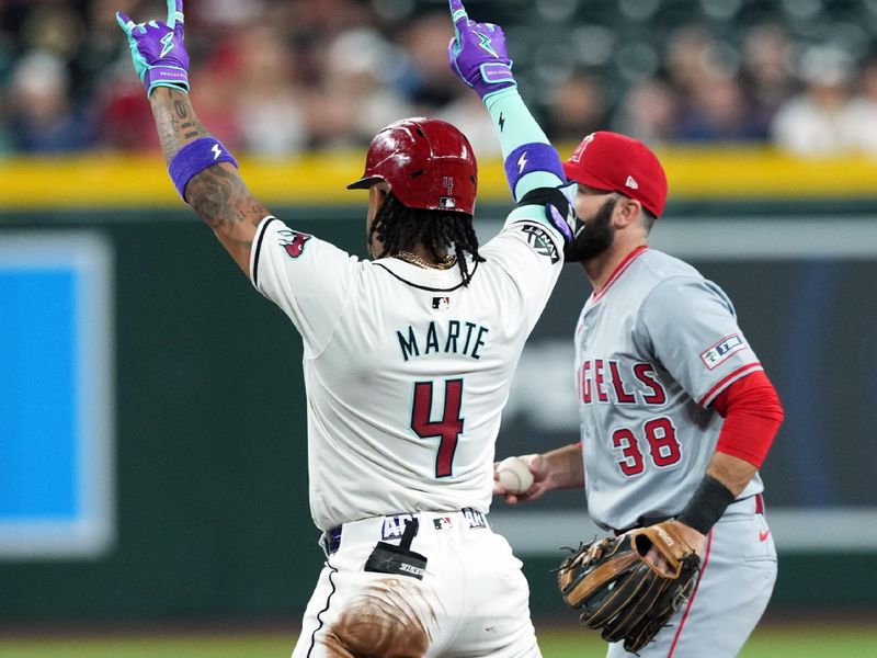 Jun 13, 2024; Phoenix, Arizona, USA; Arizona Diamondbacks second base Ketel Marte (4) reacts in front of Los Angeles Angels second base Michael Stefanic (38) after hitting a double during the first inning at Chase Field. Mandatory Credit: Joe Camporeale-USA TODAY Sports