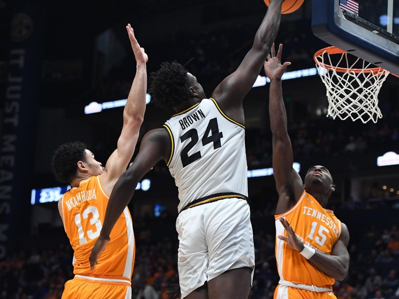 Mar 10, 2023; Nashville, TN, USA; Missouri Tigers guard Kobe Brown (24) dunks against Tennessee Volunteers forward Olivier Nkamhoua (13) and guard Jahmai Mashack (15) during the first half at Bridgestone Arena. Mandatory Credit: Christopher Hanewinckel-USA TODAY Sports