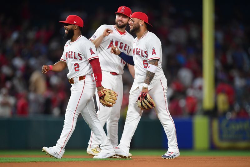 May 10, 2025; Anaheim, California, USA; Los Angeles Angels second baseman Luis Rengifo (2) first baseman Nolan Schanuel (18) and third baseman Yoán Moncada (5) celebrate the victory against the Baltimore Orioles at Angel Stadium. Mandatory Credit: Gary A. Vasquez-Imagn Images
