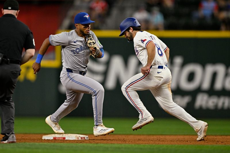 Sep 17, 2024; Arlington, Texas, USA; Toronto Blue Jays second baseman Leo Jimenez (49) puts out Texas Rangers shortstop Josh Smith (8) at second base during the fifth inning at Globe Life Field. Mandatory Credit: Jerome Miron-Imagn Images