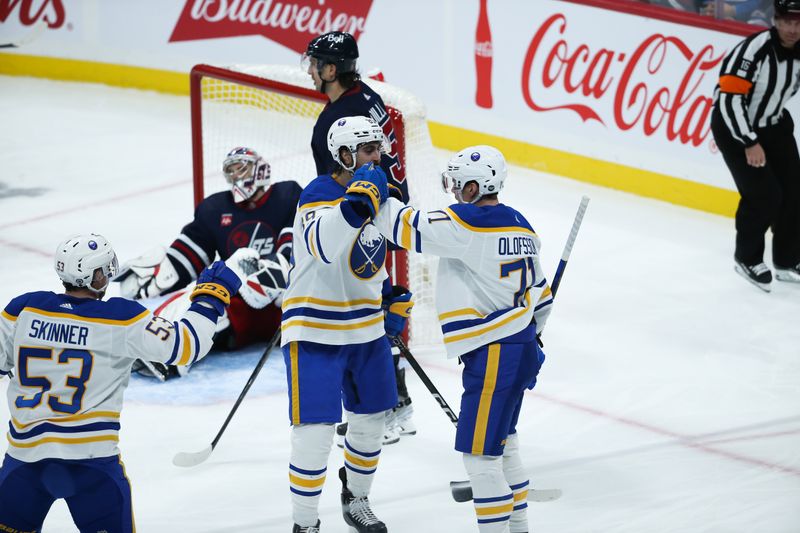 Jan 26, 2023; Winnipeg, Manitoba, CAN;  Buffalo Sabres forward Victor Olofsson (71) is congratulated by his team mates on his goal against the Winnipeg Jets during the third period at Canada Life Centre. Mandatory Credit: Terrence Lee-USA TODAY Sports