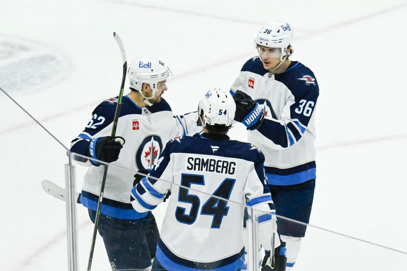 Apr 12, 2025; Chicago, Illinois, USA;   Winnipeg Jets right wing Nino Niederreiter (62) celebrates with defenseman Dylan Samberg (54) and  center Morgan Barron (36) afters scoring against the Chicago Blackhawks during the second period at United Center. Mandatory Credit: Matt Marton-Imagn Images