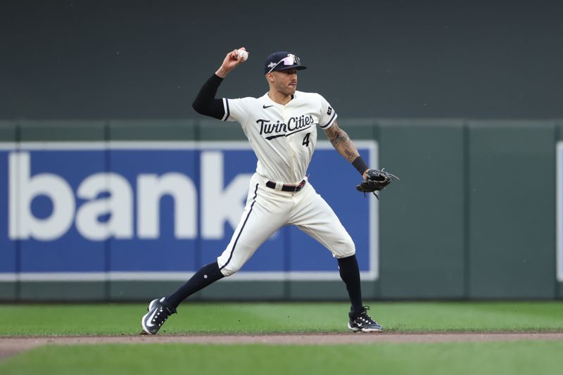 Oct 3, 2023; Minneapolis, Minnesota, USA; Minnesota Twins shortstop Carlos Correa (4) throws to first for an out in the fourth inning against the Toronto Blue Jays during game one of the Wildcard series for the 2023 MLB playoffs at Target Field. Mandatory Credit: Jesse Johnson-USA TODAY Sports