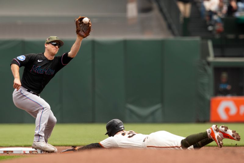 May 20, 2023; San Francisco, California, USA; San Francisco Giants second baseman Thairo Estrada (39) slides safely into second with a stolen base ahead of the the throw to Miami Marlins shortstop Joey Wendle during the first inning at Oracle Park. Mandatory Credit: D. Ross Cameron-USA TODAY Sports