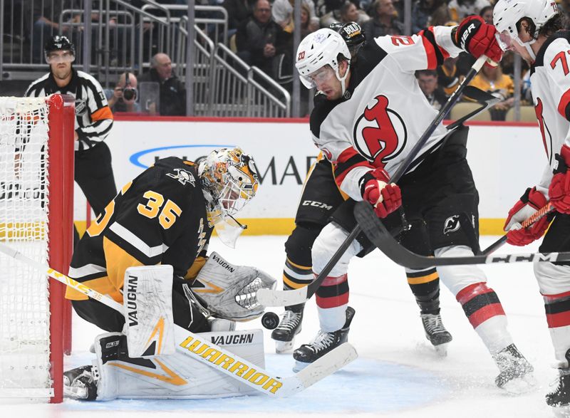 Nov 16, 2023; Pittsburgh, Pennsylvania, USA; Pittsburgh Penguins goalie Tristan Jarry (35) stops New Jersey Devils center Michael McLeod (20) during the second period at PPG Paints Arena. Mandatory Credit: Philip G. Pavely-USA TODAY Sports