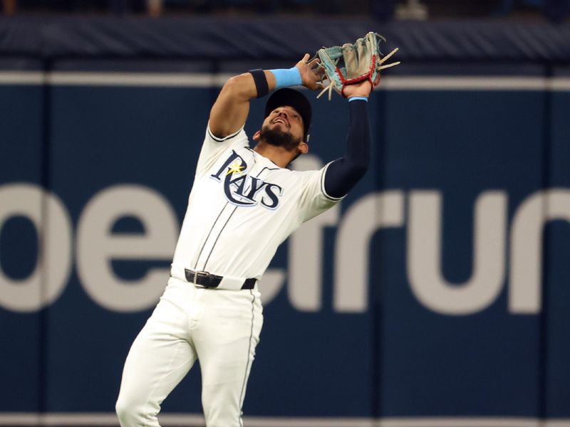 Apr 22, 2024; St. Petersburg, Florida, USA; Tampa Bay Rays shortstop Jose Caballero (7) catches a fly ball against the Detroit Tigers during the second inning at Tropicana Field. Mandatory Credit: Kim Klement Neitzel-USA TODAY Sports