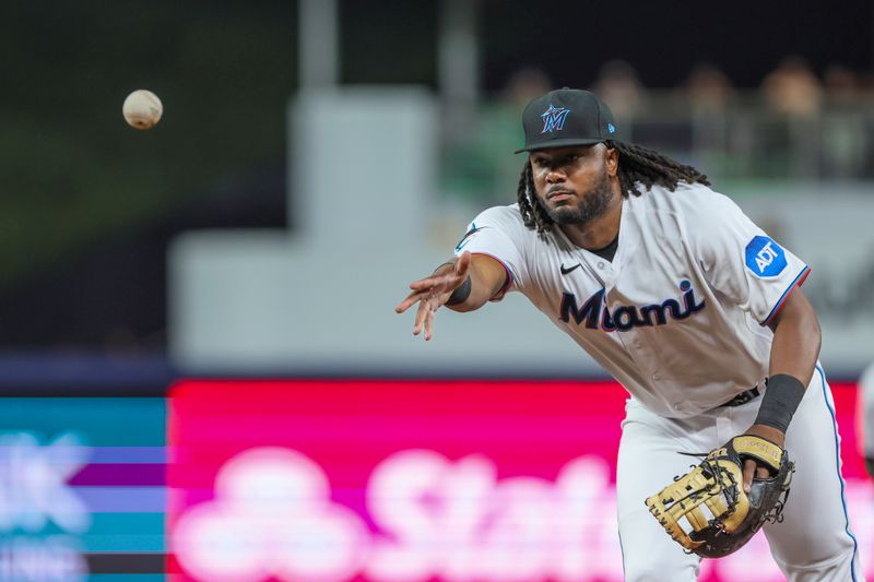 Aug 15, 2023; Miami, Florida, USA; Miami Marlins first baseman Josh Bell (9) tosses to starting pitcher Johnny Cueto (not pictured) and retires Houston Astros third baseman Alex Bregman (not pictured) during the third inning at loanDepot Park. Mandatory Credit: Sam Navarro-USA TODAY Sports