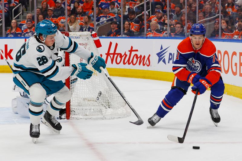 Apr 15, 2024; Edmonton, Alberta, CAN; Edmonton Oilers forward Ryan McLeod (71) and San Jose Sharks defensemen Jack Thompson (26) chase a loose puck during the first period at Rogers Place. Mandatory Credit: Perry Nelson-USA TODAY Sports