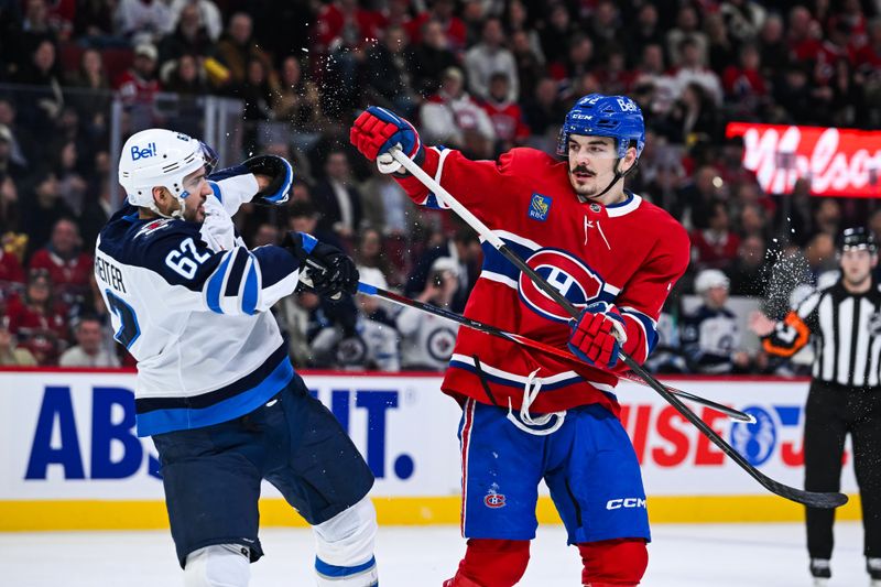 Dec 3, 2025; Montreal, Quebec, CAN; Winnipeg Jets right wing Nino Niederreiter (62) and Montreal Canadiens defenseman Arber Xhekaj (72) scuffle during the first period at Bell Centre. Mandatory Credit: David Kirouac-Imagn Images