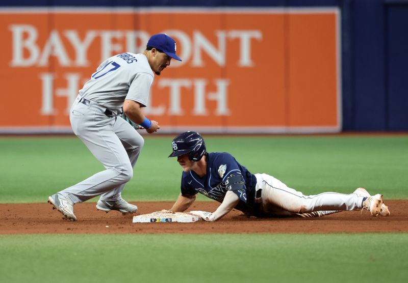 May 27, 2023; St. Petersburg, Florida, USA; Tampa Bay Rays second baseman Taylor Walls (6) slides safely into second base against Los Angeles Dodgers second baseman Miguel Vargas (17) during the ninth inning at Tropicana Field. Mandatory Credit: Kim Klement-USA TODAY Sports