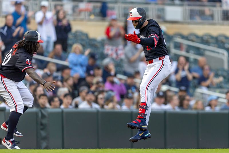 May 14, 2024; Minneapolis, Minnesota, USA; Minnesota Twins designated hitter Ryan Jeffers (27) celebrates with third base coach/outfield coach Tommy Watkins (40) after hitting a solo home run against the New York Yankees in the firs tinning at Target Field. Mandatory Credit: Jesse Johnson-USA TODAY Sports