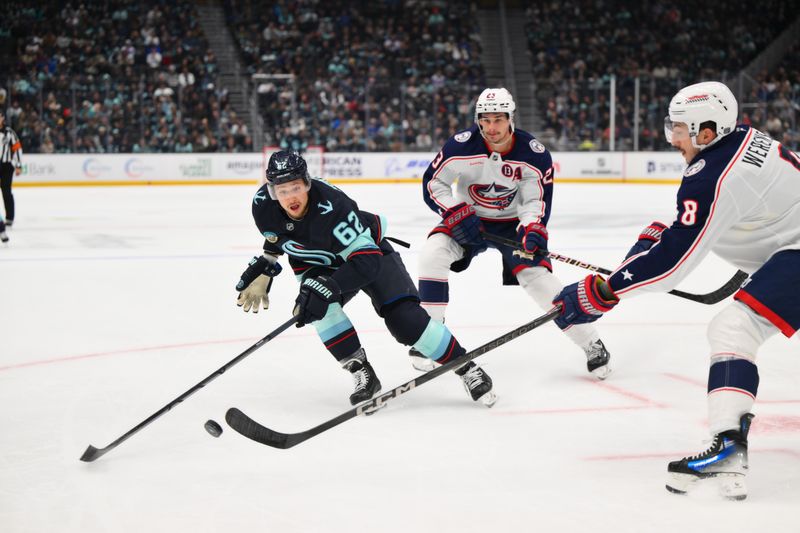 Nov 12, 2024; Seattle, Washington, USA; Columbus Blue Jackets defenseman Zach Werenski (8) passes the puck past Seattle Kraken defenseman Brandon Montour (62) during the first period at Climate Pledge Arena. Mandatory Credit: Steven Bisig-Imagn Images