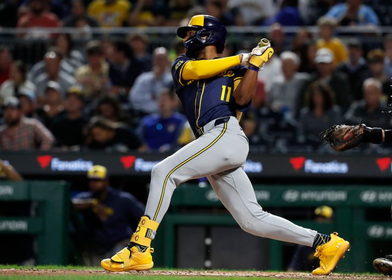 Sep 24, 2024; Pittsburgh, Pennsylvania, USA;  Milwaukee Brewers left fielder Jackson Chourio (11) hits a single against the Pittsburgh Pirates during the fourth inning at PNC Park. Mandatory Credit: Charles LeClaire-Imagn Images