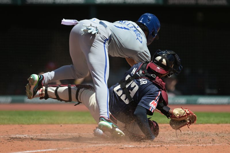 Jun 6, 2024; Cleveland, Ohio, USA; Kansas City Royals left fielder MJ Melendez (1) jumps over Cleveland Guardians catcher Bo Naylor (23) to score a run during the sixth inning at Progressive Field. Mandatory Credit: Ken Blaze-USA TODAY Sports