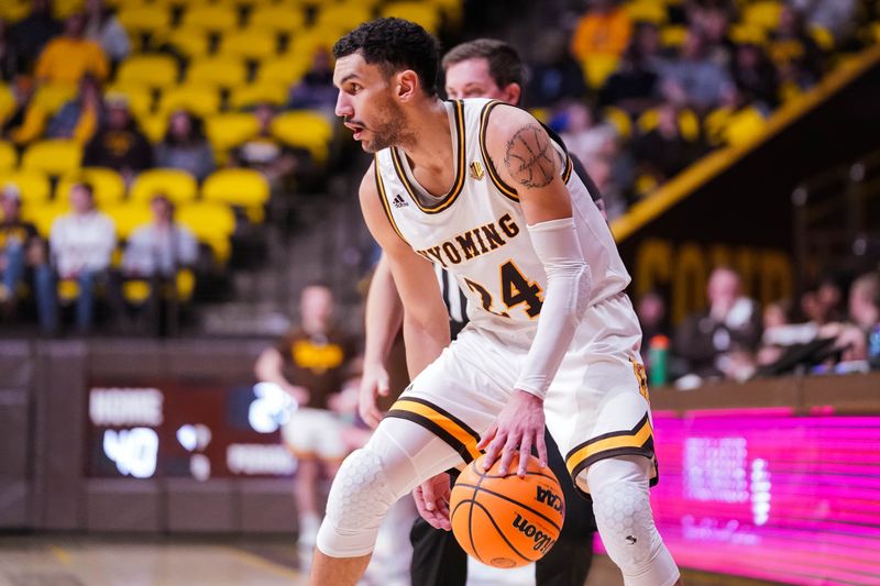 Jan 31, 2023; Laramie, Wyoming, USA; Wyoming Cowboys guard Hunter Maldonado (24) dribbles against the Fresno State Bulldogs during the first half at Arena-Auditorium. Mandatory Credit: Troy Babbitt-USA TODAY Sports