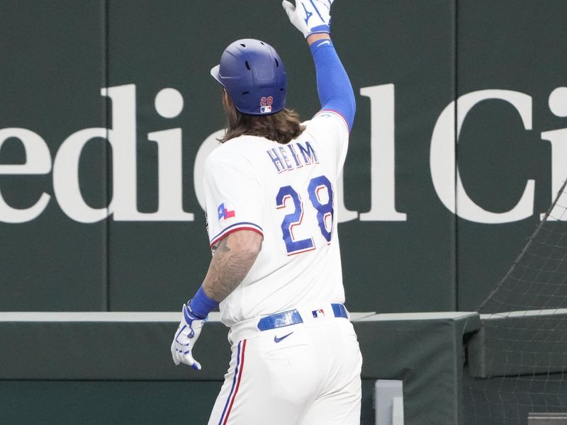 Apr 14, 2022; Arlington, Texas, USA; Texas Rangers catcher Jonah Heim (28) gestures to the crowd as he runs to the dugout following his grand slam home run against the Los Angeles Angels during the fourth inning of a baseball game at Globe Life Field. Mandatory Credit: Jim Cowsert-USA TODAY Sports