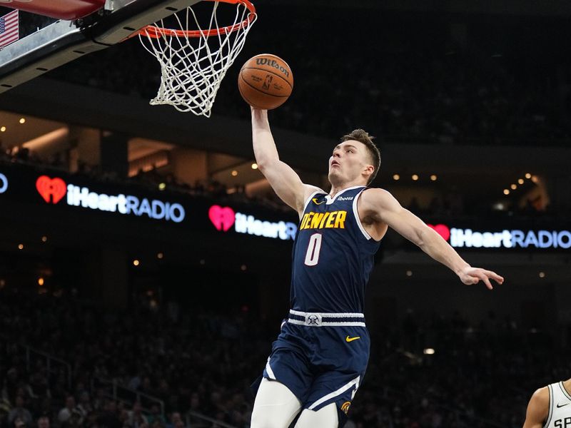 AUSTIN, TX - MARCH 15: Christian Braun #0 of the Denver Nuggets drives to the basket during the game against the San Antonio Spurs on March 15, 2024 at the Moody Center in Austin, Texas. NOTE TO USER: User expressly acknowledges and agrees that, by downloading and/or using this Photograph, user is consenting to the terms and conditions of the Getty Images License Agreement. Mandatory Copyright Notice: Copyright 2024 NBAE (Photo by Garrett Ellwood/NBAE via Getty Images)